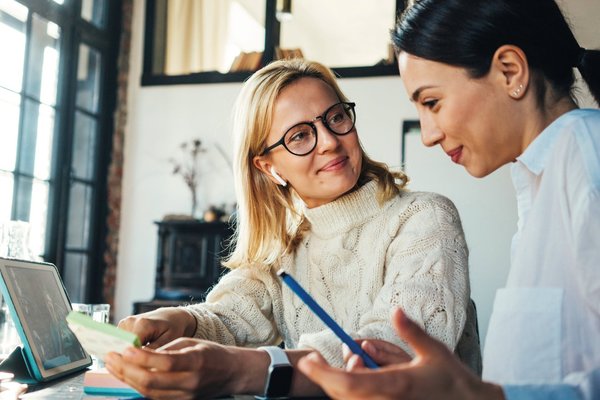 Zwei Frauen arbeiten gemeinsam in einer Coachingmaßnahme.